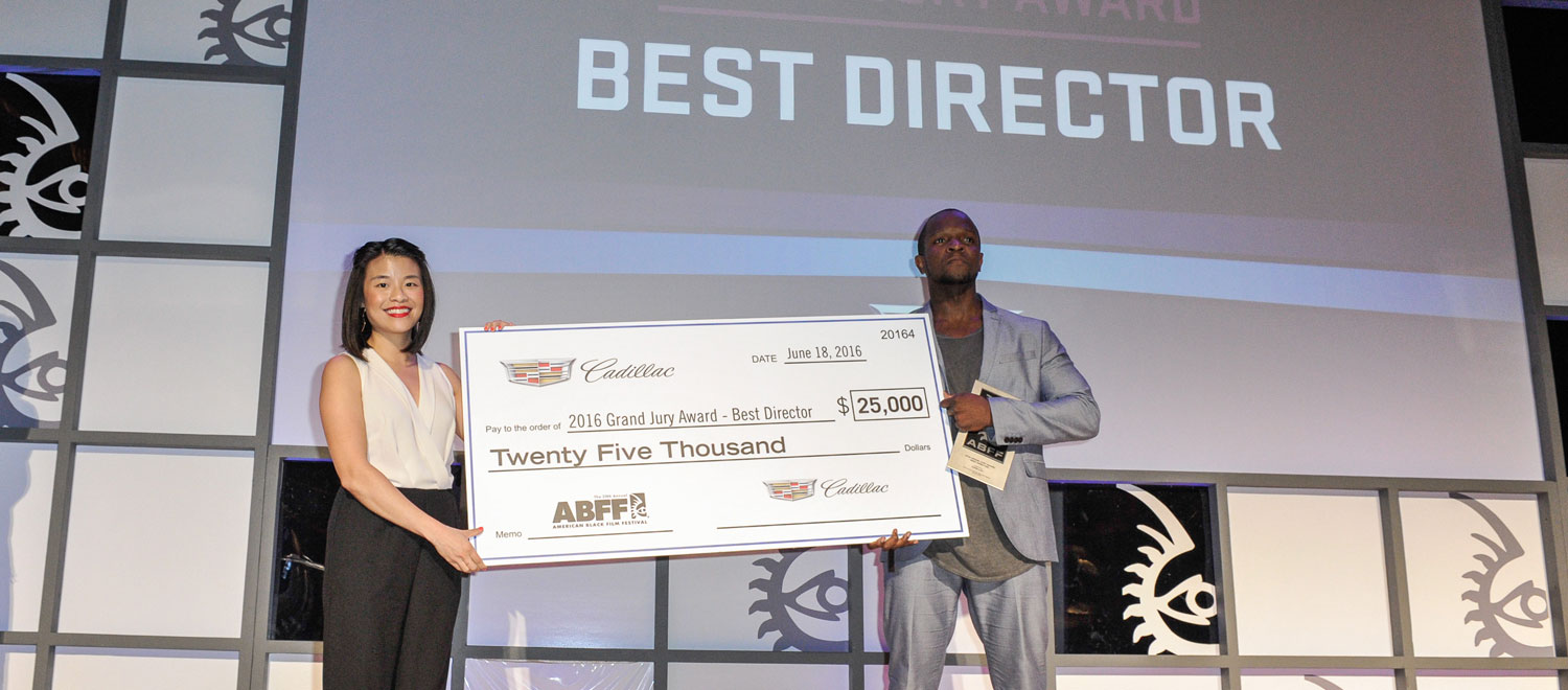Qasim Basir takes home the $25,000 Grand Jury Prize for Best Director, presented by Melody Lee (Cadillac)